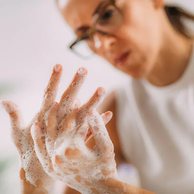 Woman washing hands with bubbly soap.