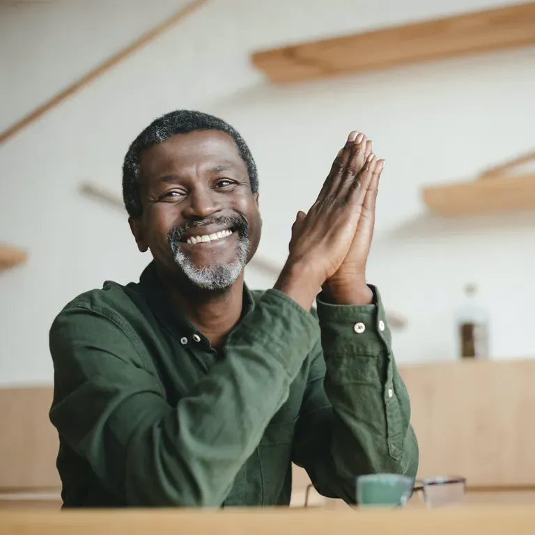 Man smiling and looking at camera.